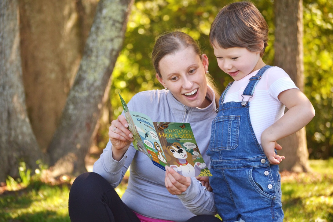 Mother and child looking at Nature's Hide & Seek Brochure