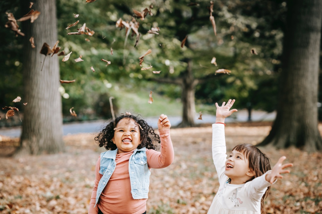 Girls playing with leaves